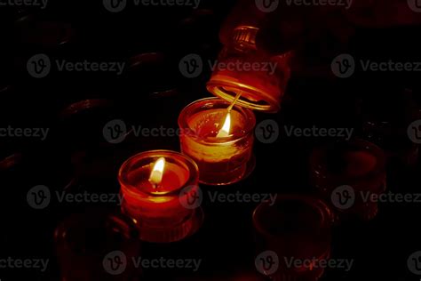 Prayer candles in votives, and insence, inside of a Catholic church ...