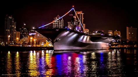 USS Midway aircraft carrier museum and city skyline lights at night on ...