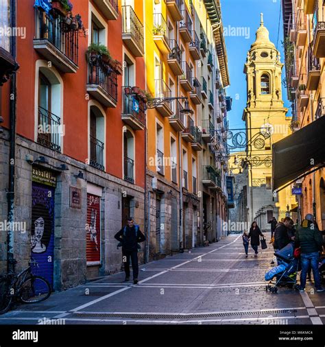 Typical colorful street in Pamplona old town with the tower bell ...