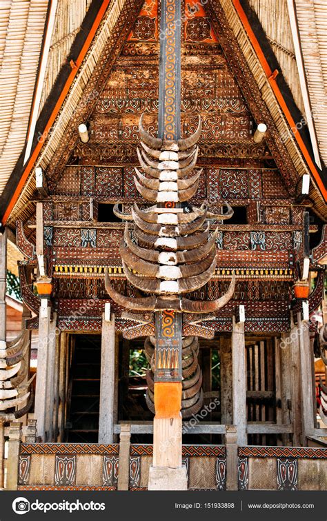 Part of tongkonan house with horns of buffaloes and wood carving and paintings, traditional ...