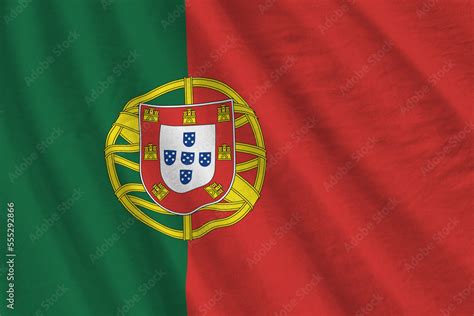 Portugal flag with big folds waving close up under the studio light ...