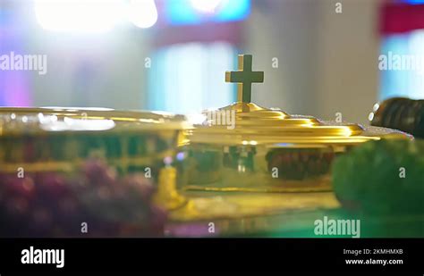 Christian Communion Ceremony, rotating shot of a golden cross on top of ...