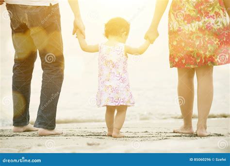 Family Holding Hands Walking on Beach Stock Photo - Image of adult ...