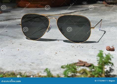 Gold Frame Aviator Black Sunglasses on Floor Stock Image - Image of ...