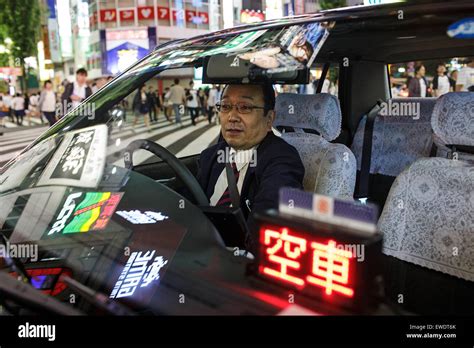 A taxi driver inside his car at night in Shinjuku, Tokyo, Japan Stock Photo - Alamy