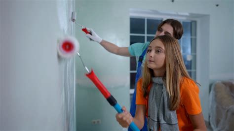 Teenage Girl Painting Wall With Father In Stock Footage SBV-347694365 ...