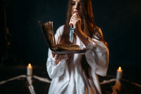 Premium Photo | Witch in white shirt sitting in the center of pentagram circle with candles ...