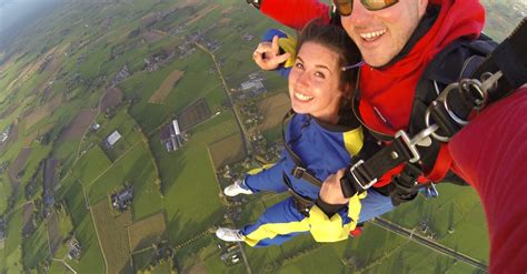 Woman and Man Wearing Overalls Sky Diving · Free Stock Photo