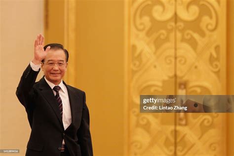 Wen Jiabao, China's premier, waves as he arrives for a news... News ...