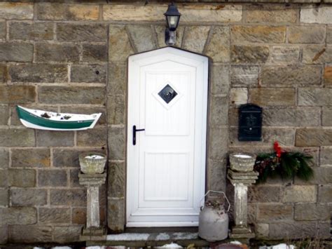 Doorway with coble fishing boat planter,... © Andrew Curtis cc-by-sa/2.0 :: Geograph Britain and ...