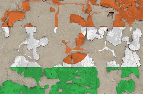 Premium Photo | Niger flag depicted in paint colors on old obsolete messy concrete wall closeup ...