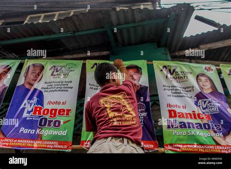 May 9, 2018 - Philippines - An election volunteer installs campaign posters ahead of the The ...