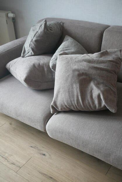 Premium Photo | Modern grey sofa with pillows in living room at home