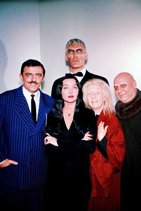 Ted Cassidy as Lurch, John Astin as Gomez, Carolyn Jones as Morticia, and Blossom Rock as ...