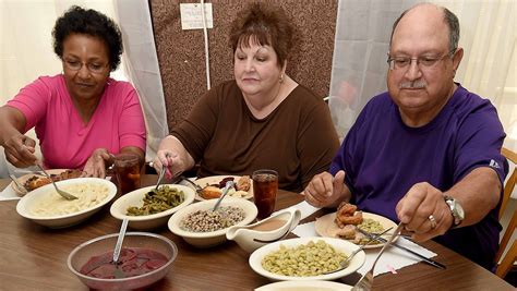 McComb's Dinner Bell round tables piled with Southern fare