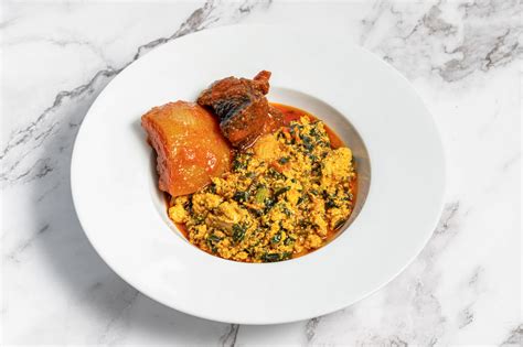 Egusi Soup with 2 Assorted served with choice of Poundo Yam, Semo or Amala - Jollof Life