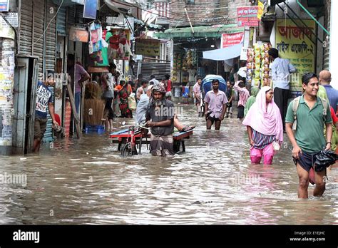 Dhaka, Bangladesh. 2nd June 2014. Rickshaw pullers move through the knee deep water at City’s ...