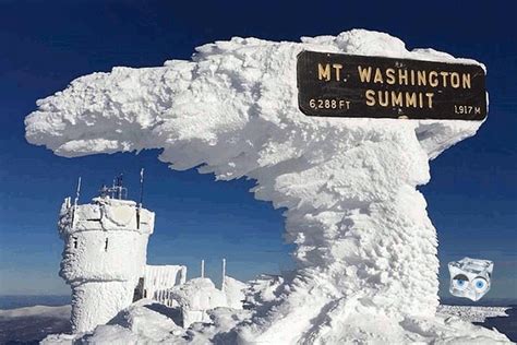 there is a sign that says mt washington summit in front of some snow ...