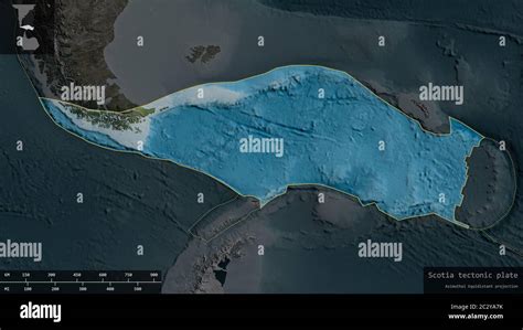 Scotia plate shape outlined on a darkened and desaturated background of the satellite map with ...