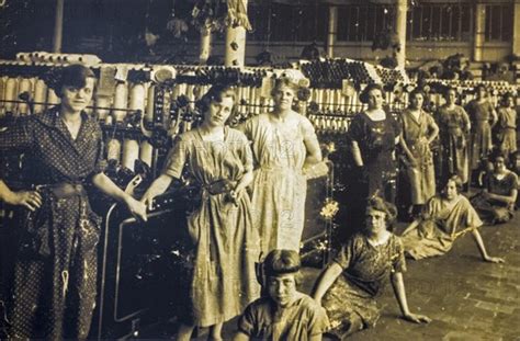 Old archival photograph showing female workers posing in spinning mill ...