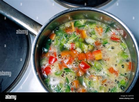 Simple vegetable soup simmering in a pot Stock Photo - Alamy