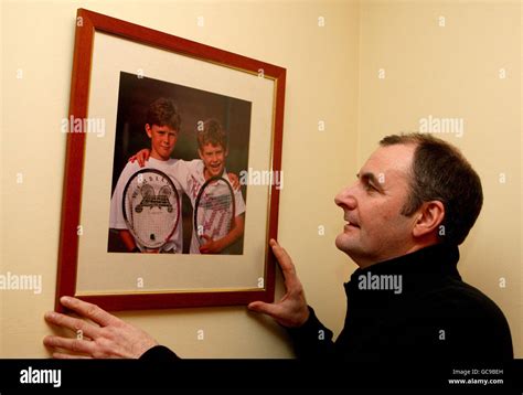 Andy Murray's father Will Murray looks at a picture of his sons Jamie ...