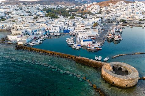 Aerial view of a coastal path & Church at Agios Mamas Beach, next to aristocratic villas on the ...