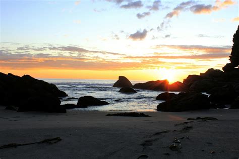 Beach and Rocks Under Orange Sunset · Free Stock Photo