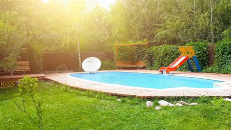 Backyard pool with slide 2191815 Stock Photo at Vecteezy