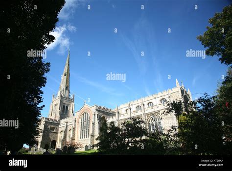 Thaxted Parish Church in Thaxted Essex with a bright blue sky and some trees Stock Photo - Alamy