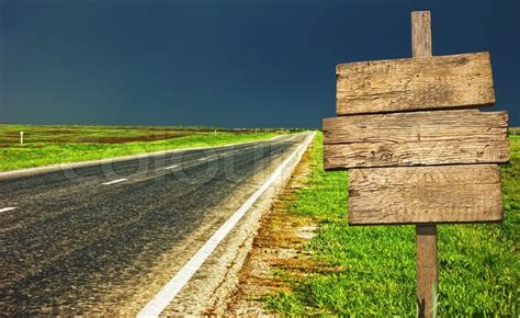 Old wooden sign at the country road | Stock Photo | Colourbox