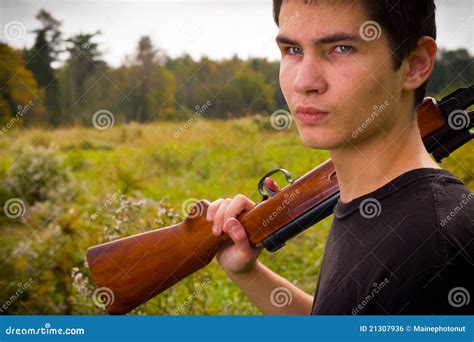 Young man with rifle stock photo. Image of outdoor, season - 21307936