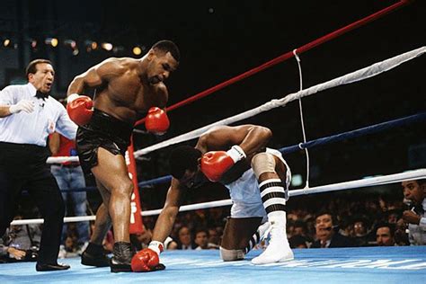 Mike Tyson forces Michael Spinks to take a knee a minute into their fight on June 27, 1988, in ...