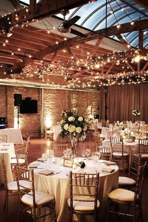 Indoor winter wedding reception with twinkly lights and classic wedding ...