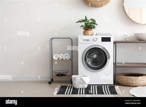 Interior of bathroom with modern washing machine Stock Photo - Alamy