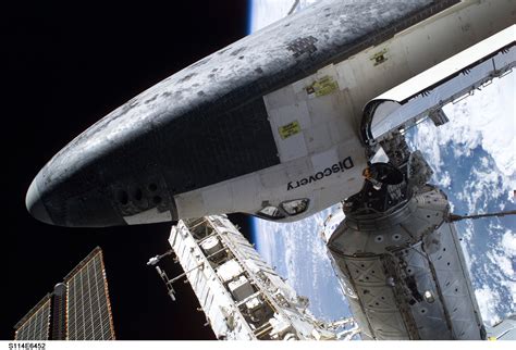 The Space Shuttle Discovery, docked to the Destiny laboratory of International Space Station ...