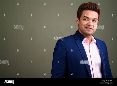 Indian businessman wearing suit against colored background Stock Photo ...