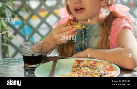 Girl Eating Pizza Stock Video Footage - Alamy