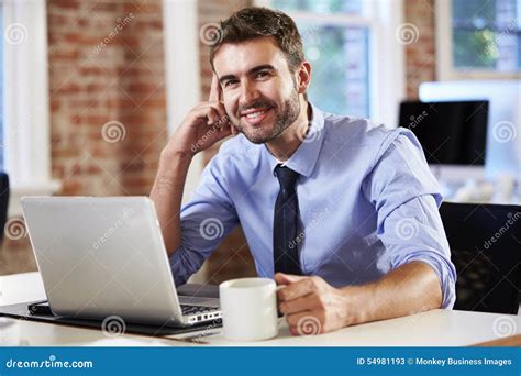 Man Working at Laptop in Contemporary Office Stock Image - Image of sitting, laptop: 54981193