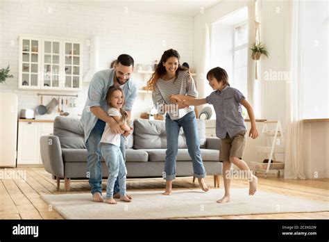 Happy family playing funny game having fun together Stock Photo - Alamy