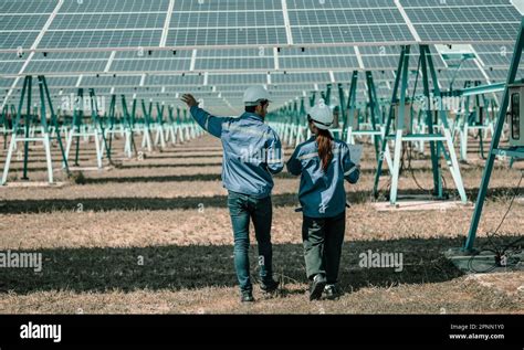 Solar design engineers visually inspect photovoltaic array installation ...