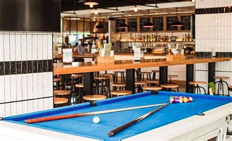 a pool table in the middle of a bar