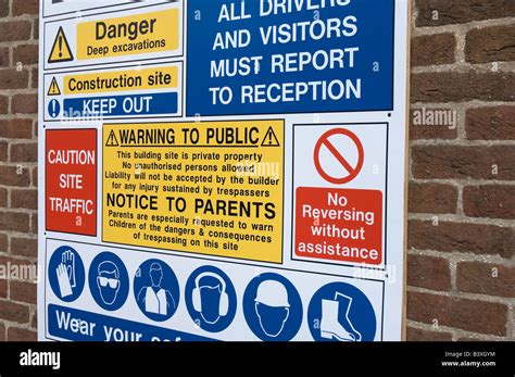 Entrance to construction site health and safety regulations warning sign on brick wall England ...