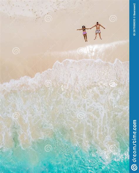 Drone View from Above at a Tropical Beach with Men and Woman Laying Down in the Seychelles Stock ...