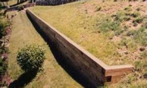 How to install a wood timber retaining wall on your property to create ...