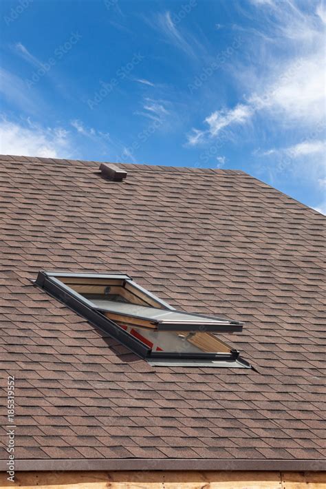 Roof with mansard windows and asphalt shingles. Stock Photo | Adobe Stock