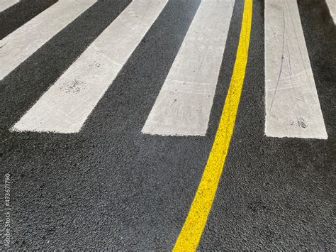 zebra crossing with yellow line Stock Photo | Adobe Stock