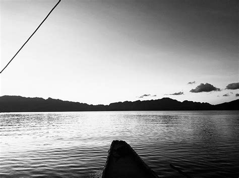 Boat in the Water with Mountains in the Background