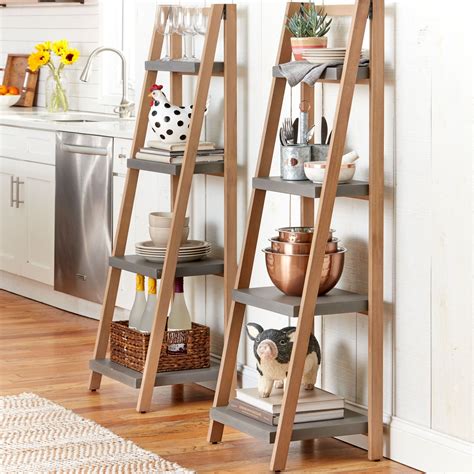 three wooden shelves with pots and pans on them in a kitchen next to a stove