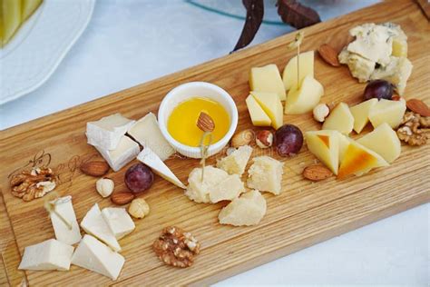 Wooden Tray with Cheese Cuts, Nuts, Grapes and Honey. Stock Photo - Image of festive, italian ...